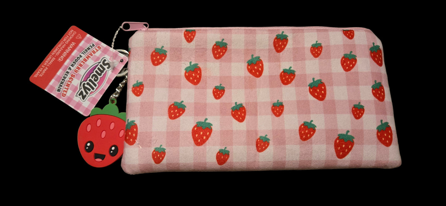 Pink checkered pouch with strawberry pattern and keychain on a gray surface