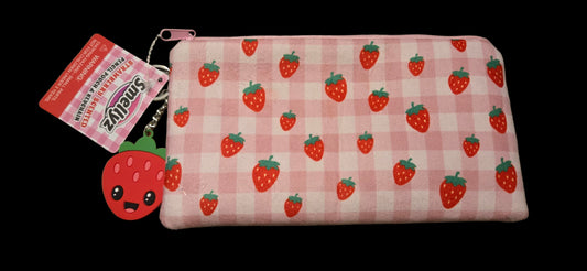 Pink checkered pouch with strawberry pattern and keychain on a gray surface