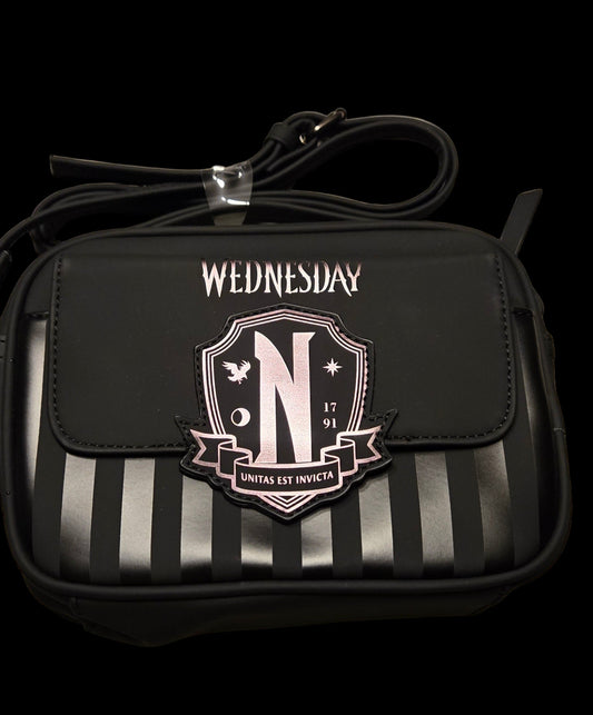 Black crossbody bag with striped design and 'Wednesday' text on a black background