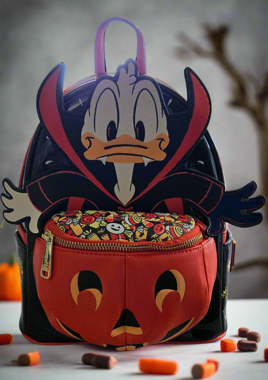 Pumpkin-shaped backpack with cartoon character design on a neutral background